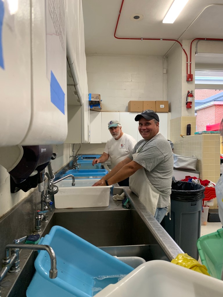 Larry and Tim thaw fish. Hundreds of pounds of flounder are thawed through the night.